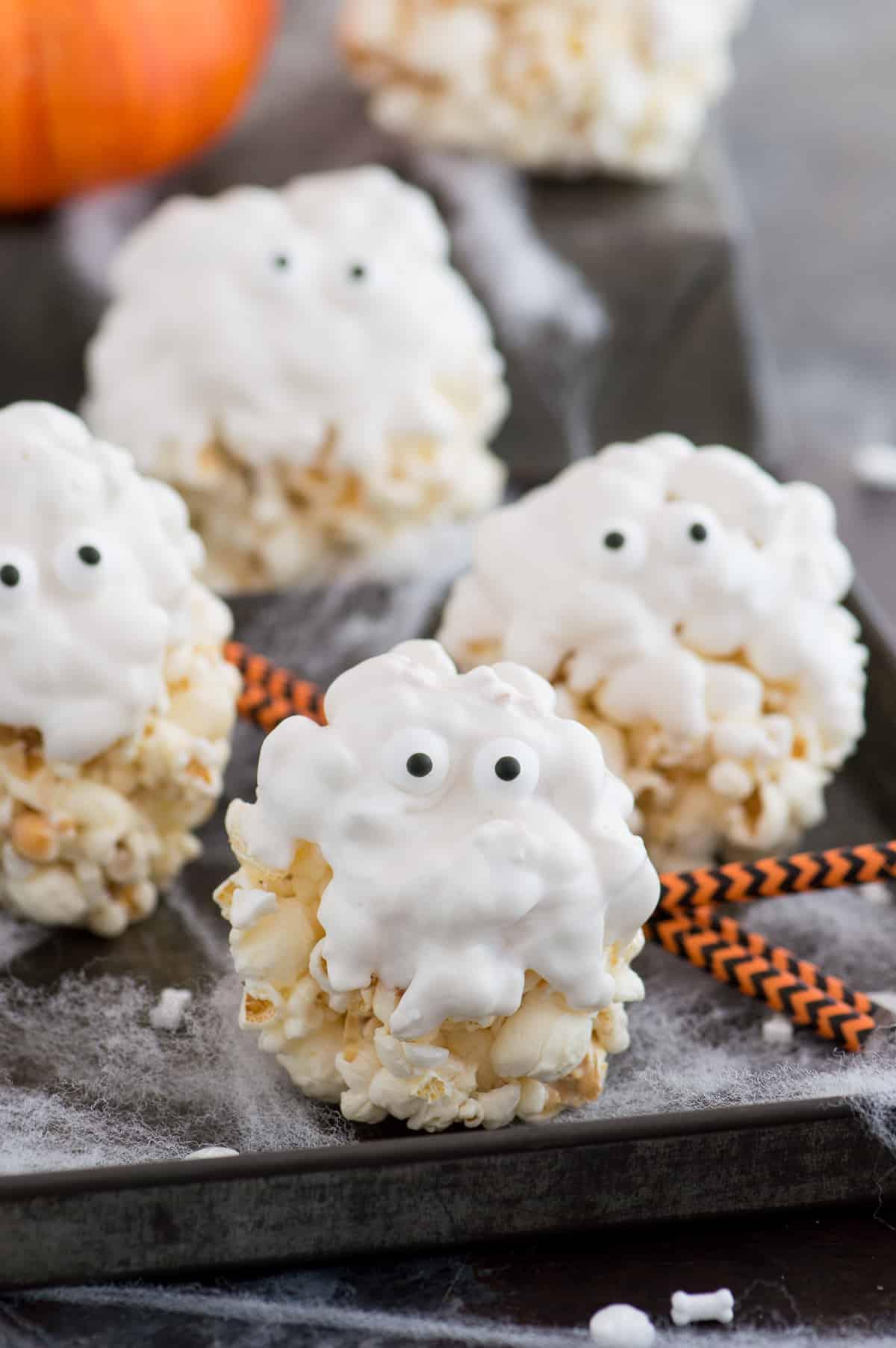 Palle di Popcorn Fantasma 2 Palle di popcorn ricoperte di cioccolato bianco con occhietti di zucchero per assomigliare a fantasmi