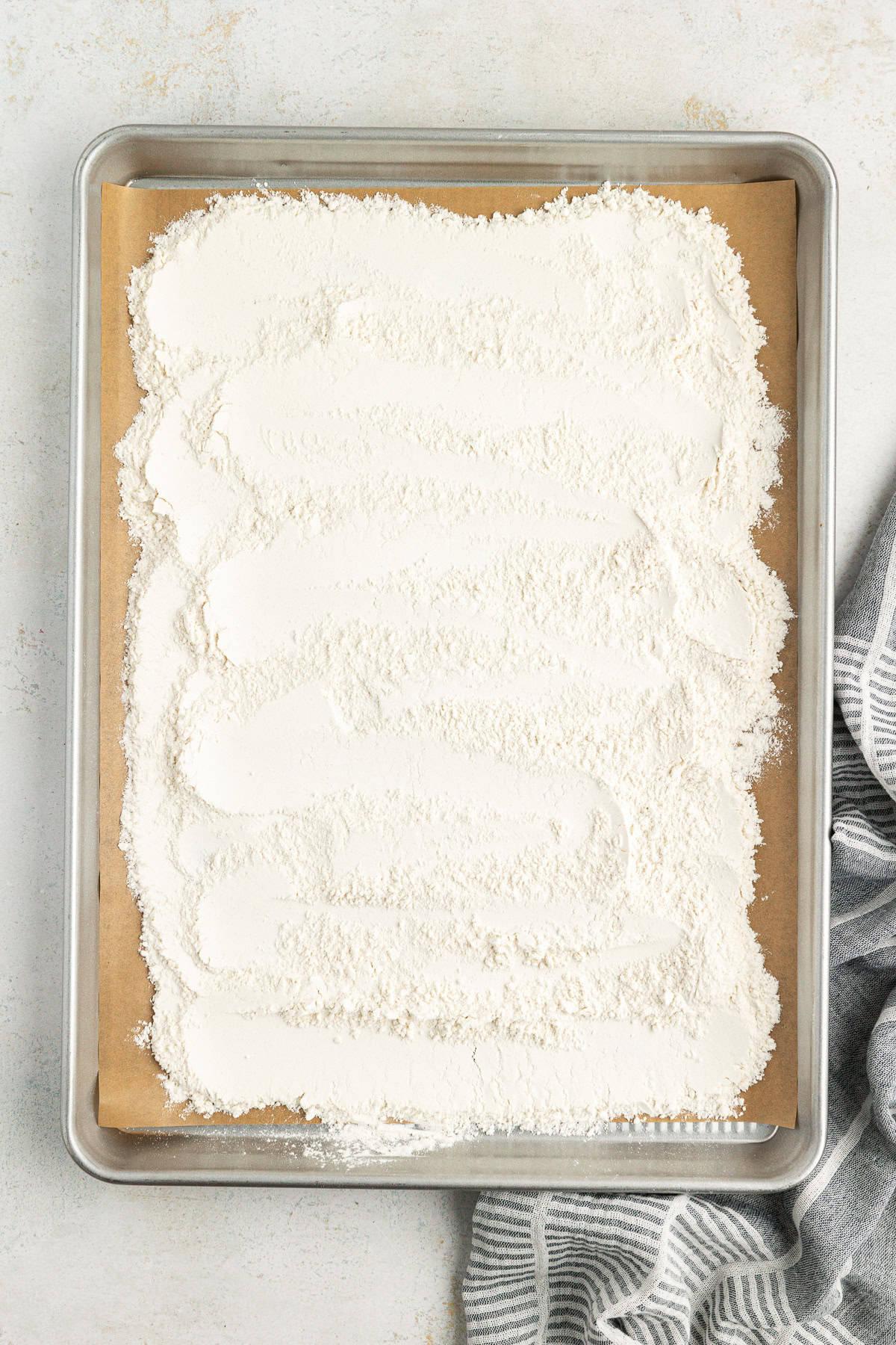 **Semplice Impasto per Biscotti Commestibile** 11 a baking sheet lined with parchment paper with all-purpose flour spread out all over it