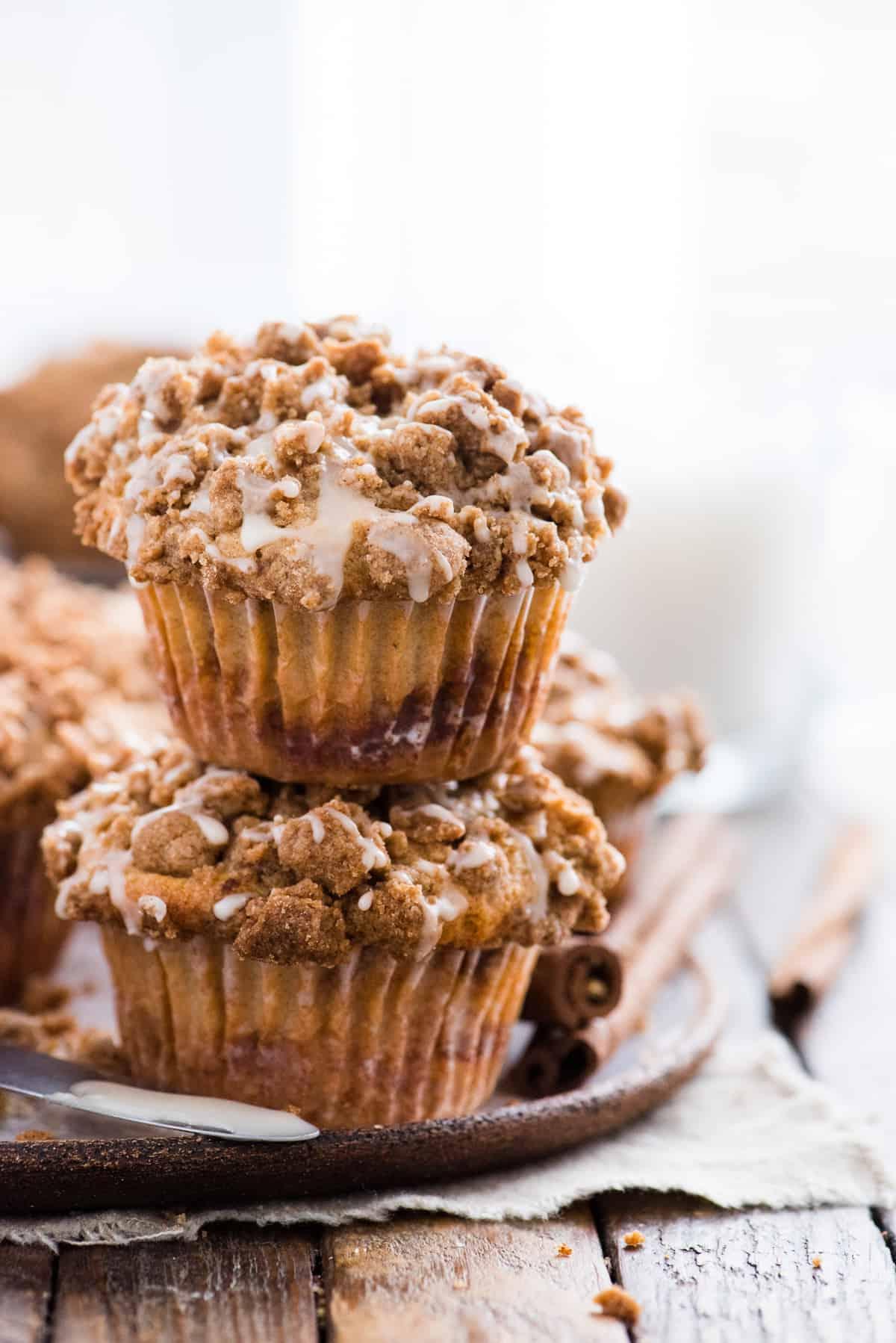 Muffin alla Sbriciolata 3 due muffin al caffè con copertura crumble impilati uno sull'altro su sfondo di legno