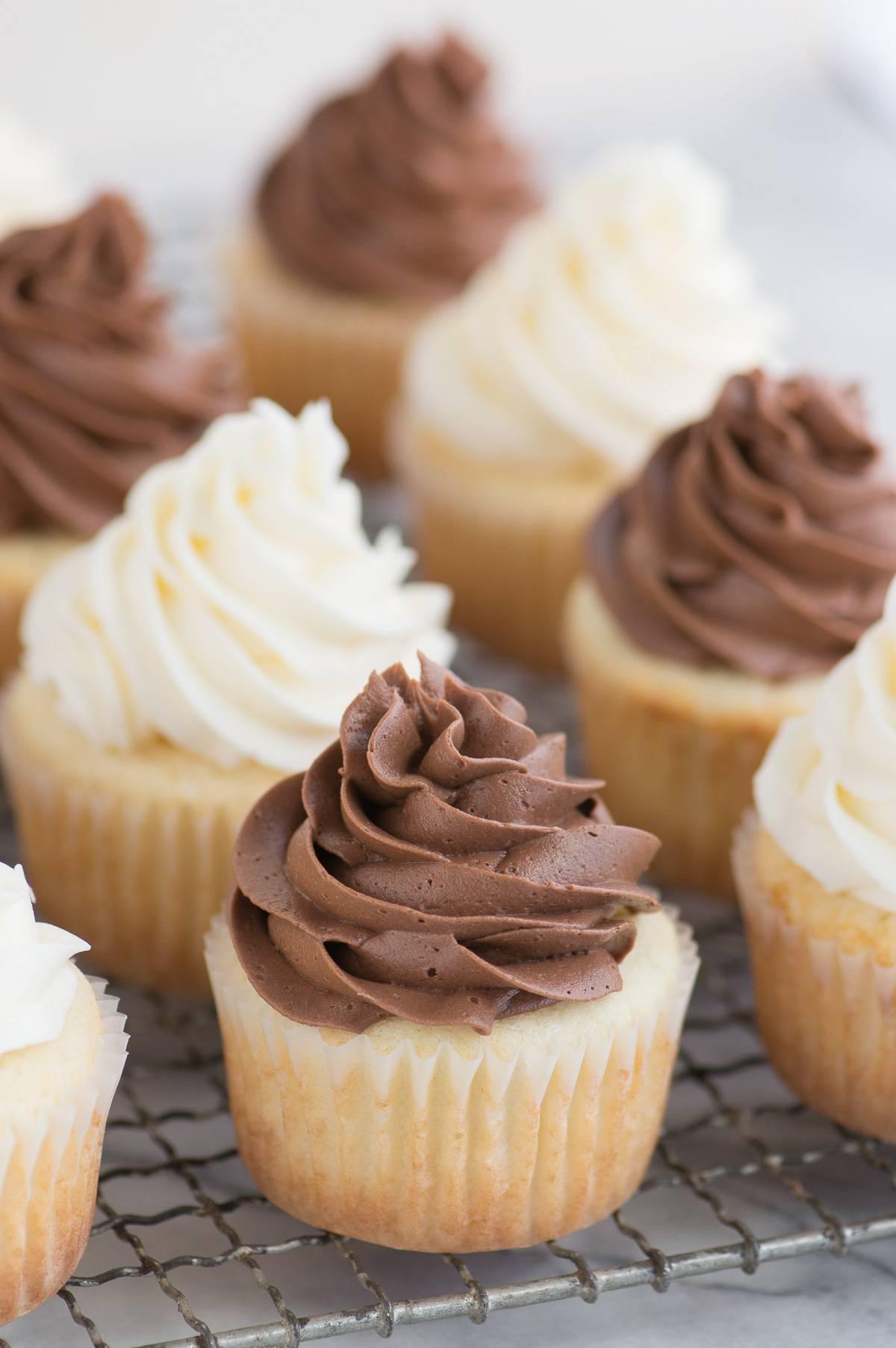 Questa ricetta di CUPCAKE BIANCHI CLASSICI è STUPEFACENTE per la sua semplicità e bontà! Questa è la nostra ricetta preferita per cupcake bianchi perché è così incredibilmente umida, soffice e saporita. Accoppia questi cupcake con una deliziosa crema al burro alla vaniglia o al cioccolato per un'esperienza completa.