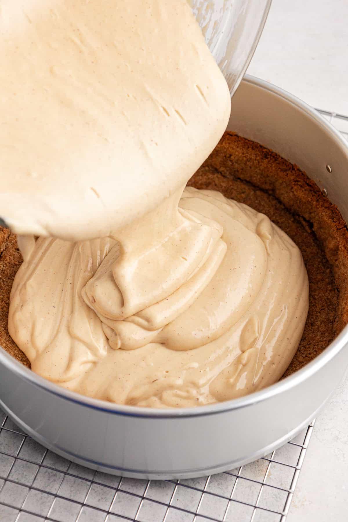 La Migliore Ricetta per Cheesecake alla Torta Pecan 8 Impasto della cheesecake versato in una tortiera a cerniera con la base di biscotti graham