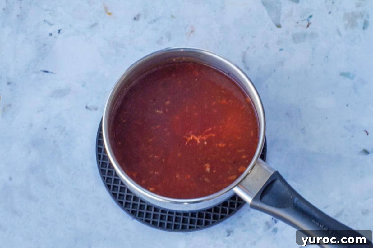 Sauce with cornstarch added as a thickener in small saucepan.