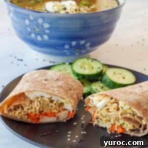 Ramen Roll 8 Ramen wrap on a black plate with cucumbers and ramen soup in the background