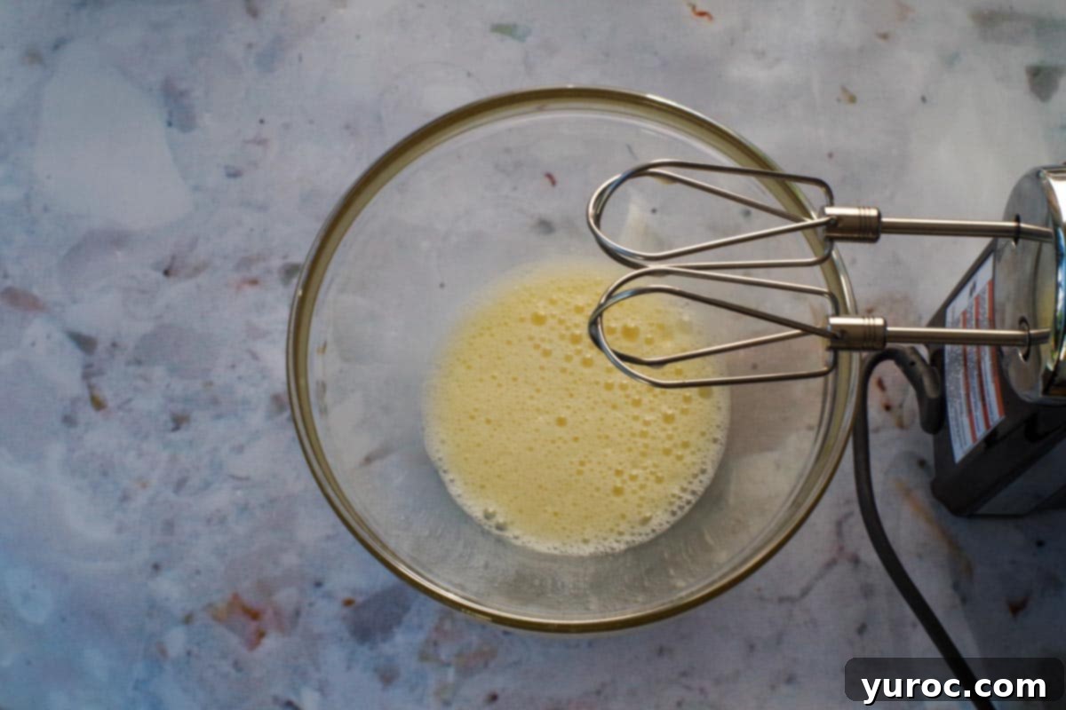 Egg and Oil beaten together in a medium glass bowl.