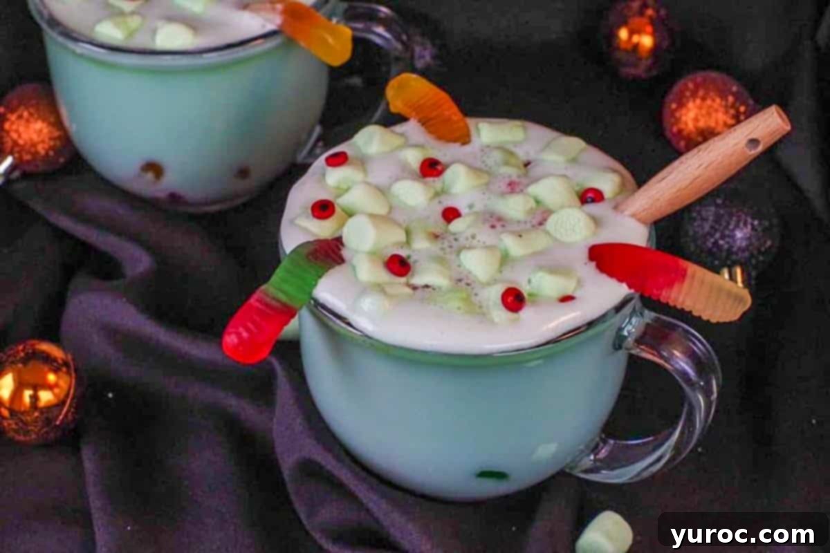 Mystic Cauldron Cocoa 2 Halloween hot chocolate in a clear mug with a black background