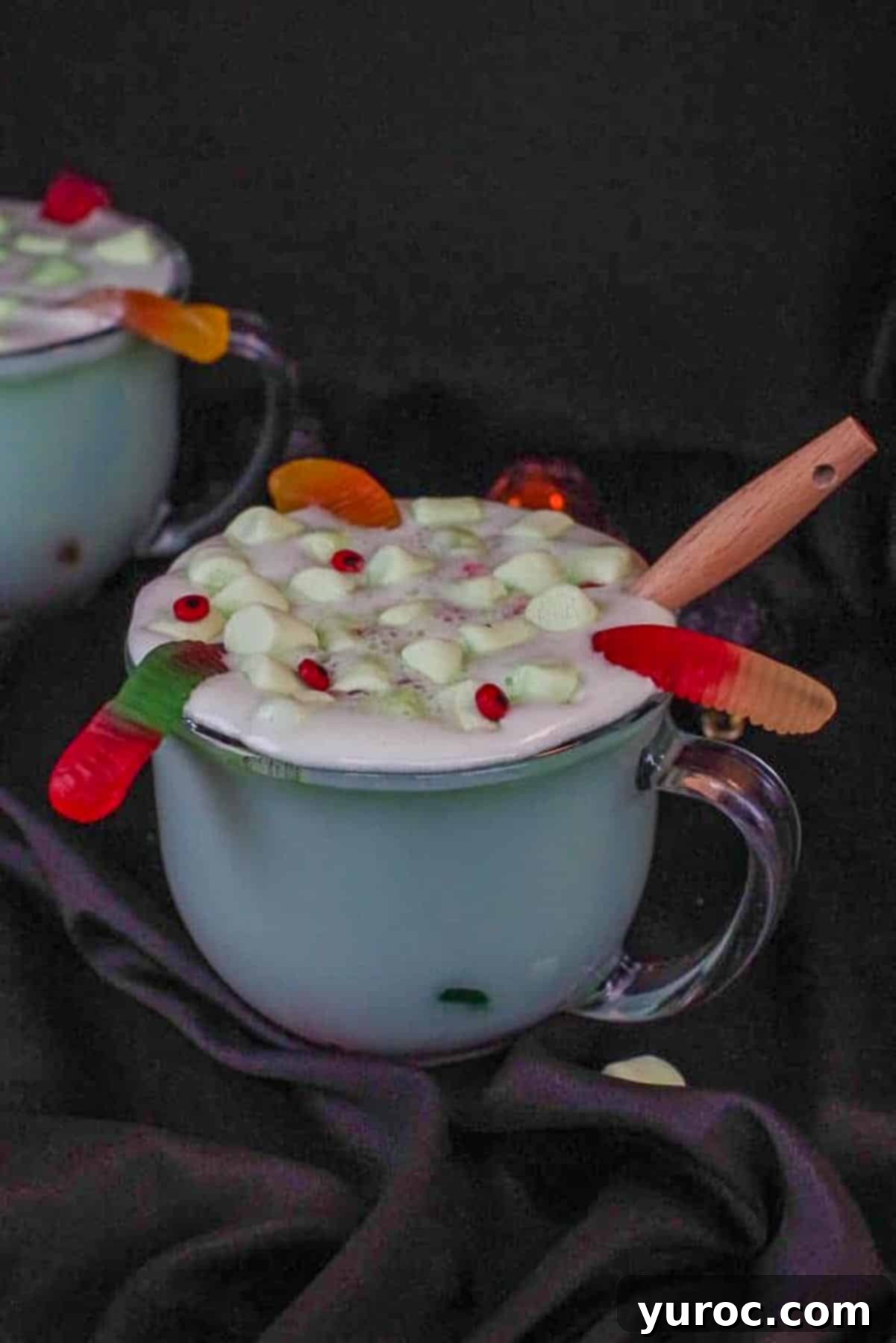 Mystic Cauldron Cocoa 7 Halloween hot chocolate in a clear mug with a black background