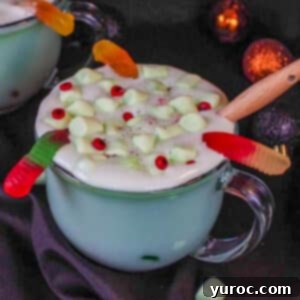 Mystic Cauldron Cocoa 8 Halloween hot chocolate in a clear mug with a black background
