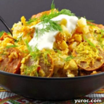 Ukrainian crock pot casserole in a black bowl on a Ukrainian patterned tablecloth