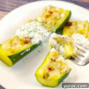 two pierogi zucchini boats on a white plate with a piece of zucchini boat on a fork