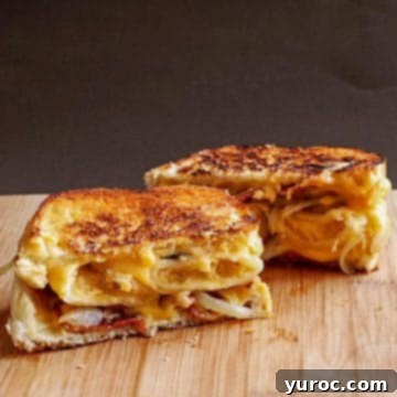Perogie Grilled Cheese Sandwich on a cutting board with black background