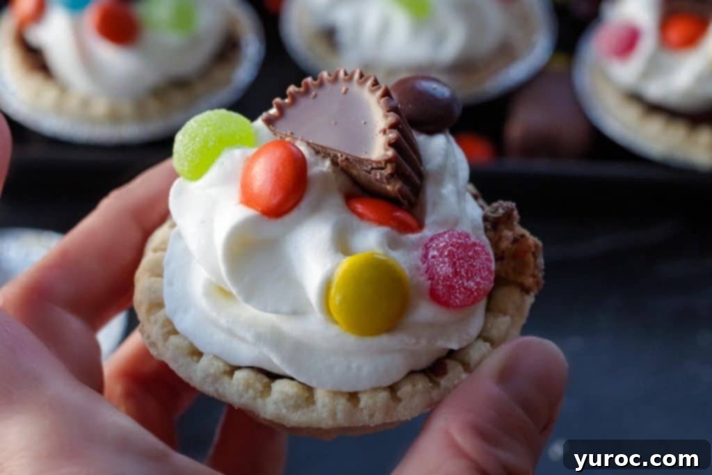Halloween Candy Remix Tarts 9 A finished Leftover Halloween Candy Tart, beautifully adorned with whipped cream and a variety of candies.
