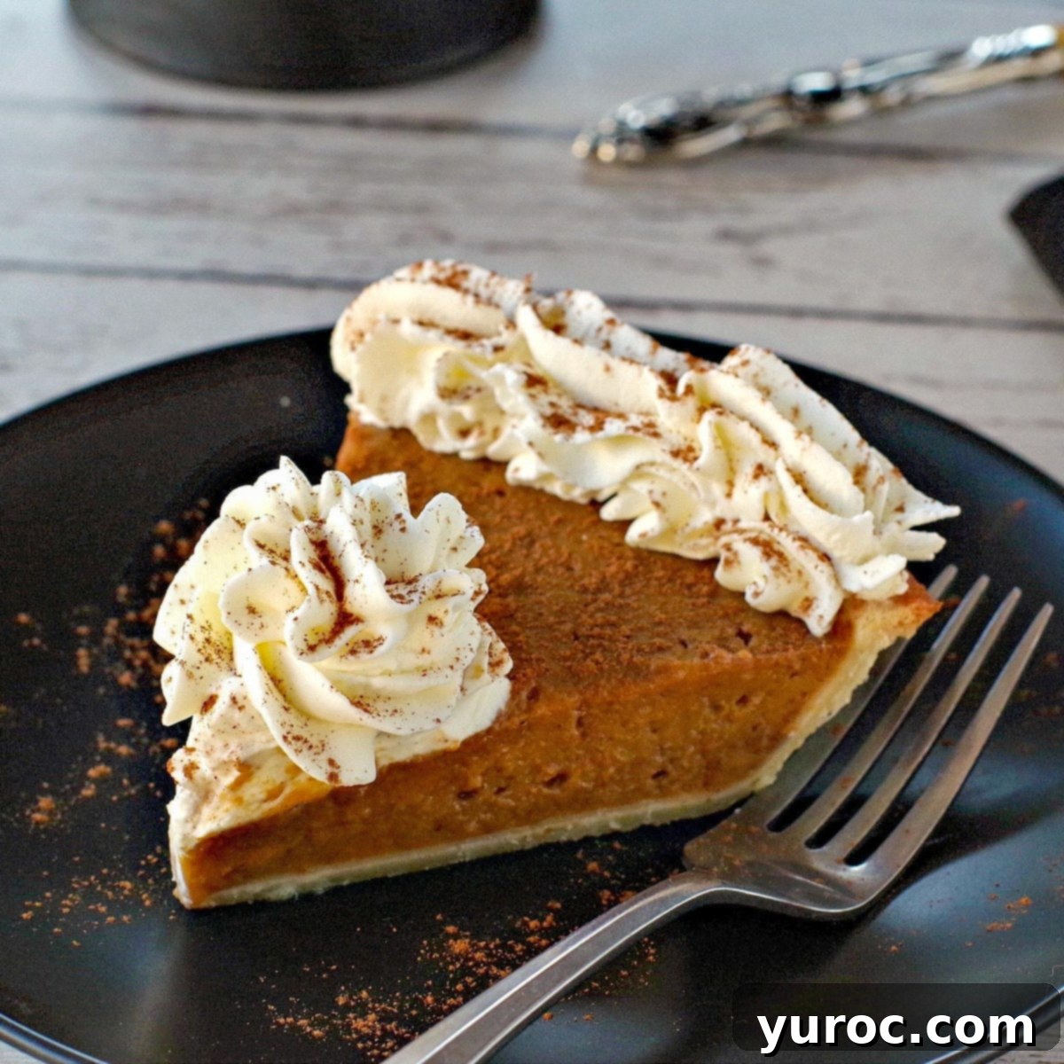 Unlock the Secrets of Whole Pumpkin Cooking and Homemade Purée 5 piece of pumpkin pie with whipped cream on a black plate with black platter stand in the background, with pie on platter