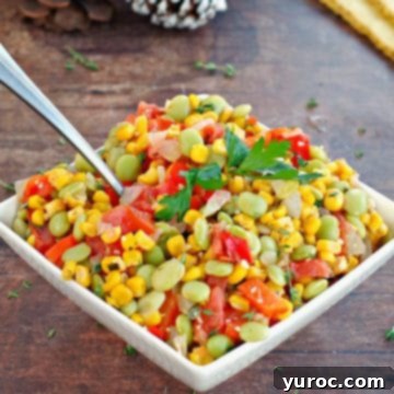 healthy corn succostash in a white bowl on brown wooden surface