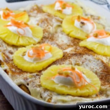 Whole Carrot Cake French Toast Casserole with pineapples dotted with whipped cream and grated carrots on top