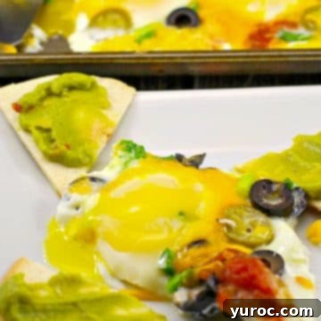 one sheet pan mexican egg on a plate with tortilla toast and sheet pan with more eggs in the background