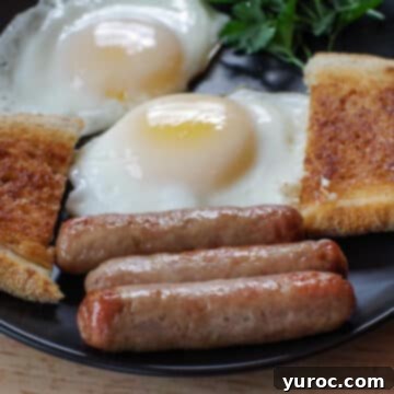 3 air fryer turkey sausages on a black plate with eggs and toast and parsley