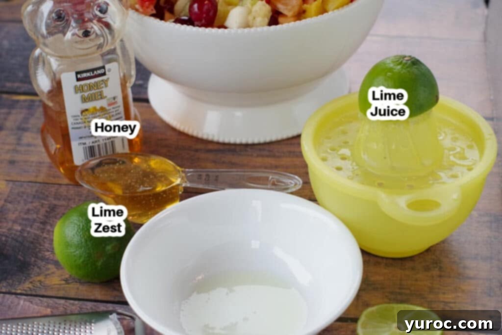Labelled ingredients for old fashioned fruit salad dressing: liquid honey, fresh lime juice, lime zest.