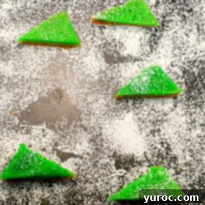 lime squares with powdered sugar on a cutting board with powdered sugar and space where one has been removed
