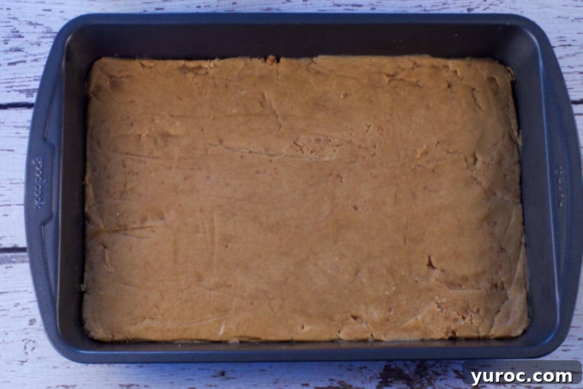 Base dough pressed into a 9x13 pan.
