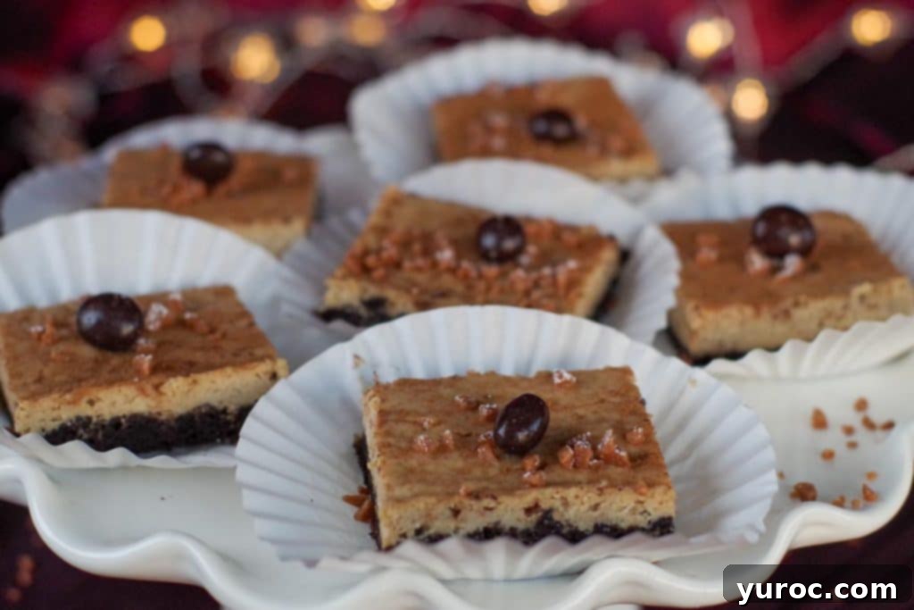 eggnog cheesecake bars on paper holders, on a white platter