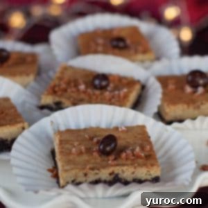 eggnog cheesecake bars on paper holders, on a white platter