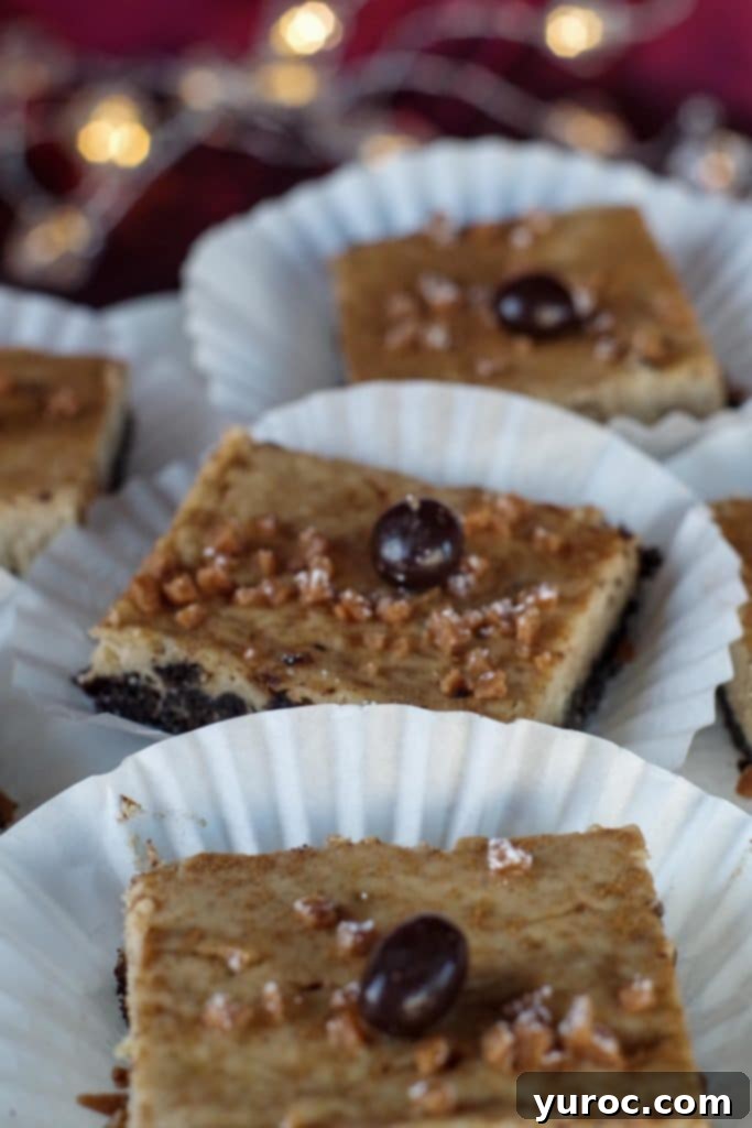 eggnog cheesecake bars on paper holders, on a white platter
