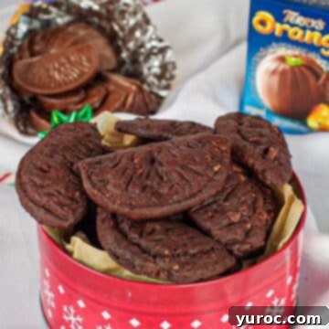 A festive red Christmas tin filled with delicious Terry's chocolate orange cookies, perfect for sharing.
