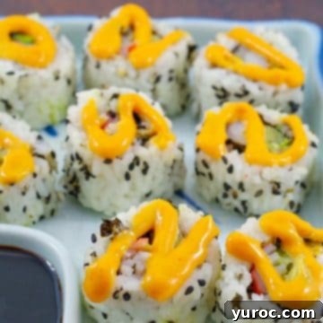 Delectable homemade California rolls drizzled with sriracha mayonnaise, showcasing vibrant colors and fresh ingredients.