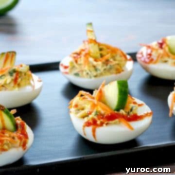 Banh Mi Devilled Eggs artfully arranged on a narrow black serving platter, highlighting their fresh garnishes.