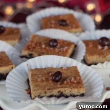 Elegant eggnog cheesecake bars, nestled in paper holders, presented beautifully on a white platter.