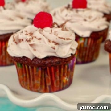 Luxurious chocolate tiramisu cupcakes elegantly displayed on a pristine white cake platter, inviting indulgence.