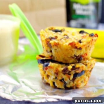 Two enticing chicken and wild rice cups presented on foil, with a lunch bag, juice, and a container subtly blurred in the background.