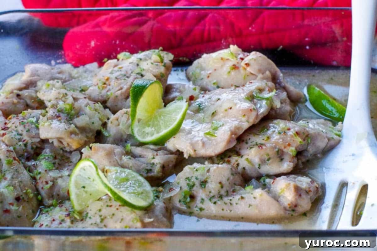 honey lime chicken in a glass casserole dish with carrots and rice in the background