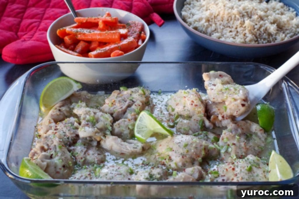 honey lime chicken in a glass casserole dish with carrots and rice in the background