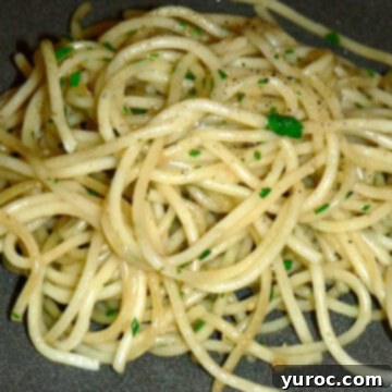 garlic olive oil pasta on a grey plate