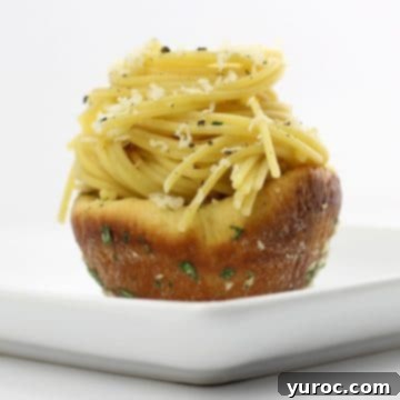 leftover spaghetti in garlic bread bowl on white plate
