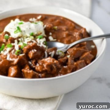 11 Legendary Chili Recipes 4 Texas chili in a white bowl with spoon