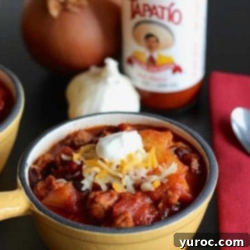 11 Legendary Chili Recipes 8 Pineapple chili in a yellow bowl with chili ingredients in the background