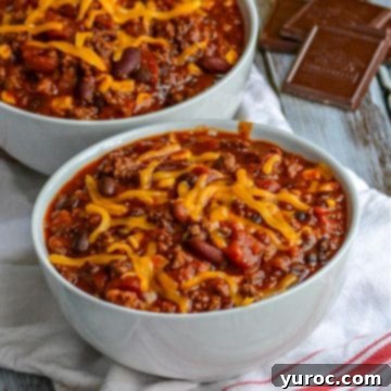 11 Legendary Chili Recipes 9 2 bowls of Dad's secret ingredient chili with squares of chocolate in the background