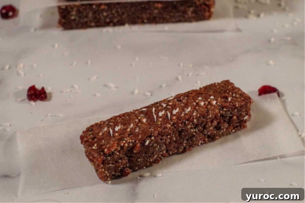 No bake energy bar on a counter with coconut scattered around