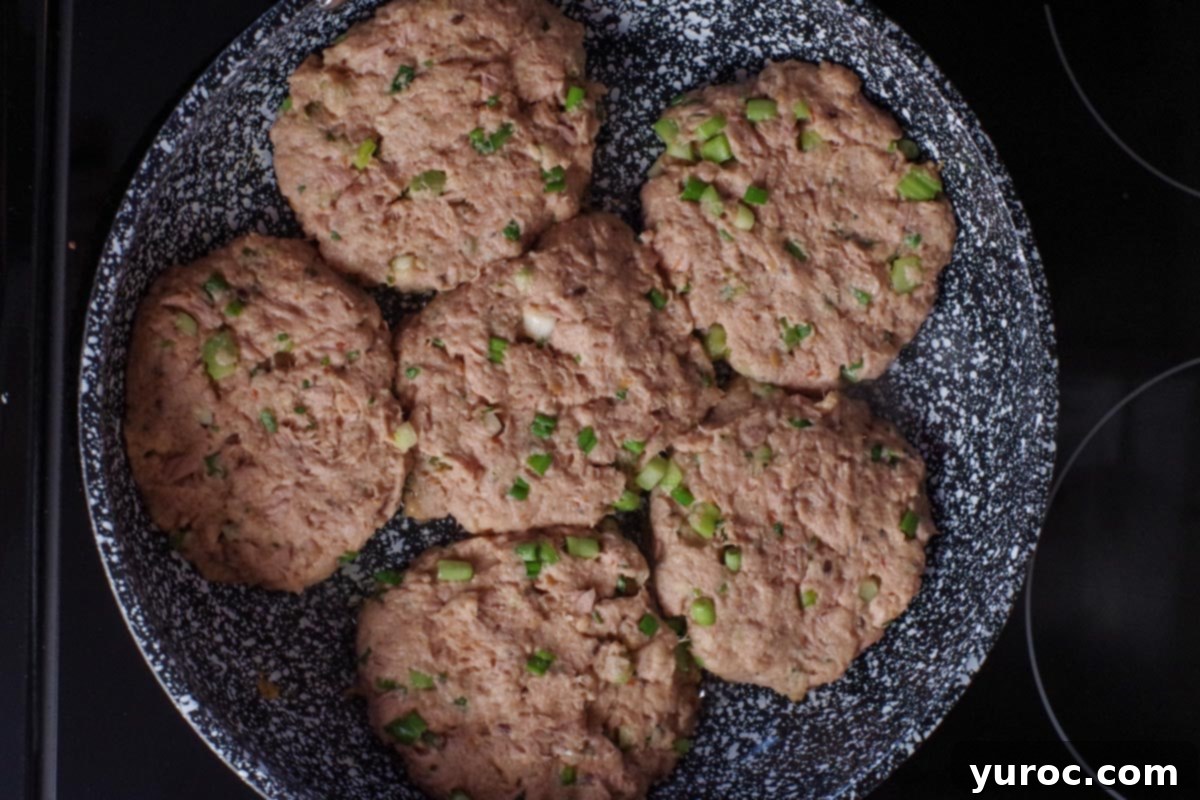 uncooked tuna burgers in a frying pan