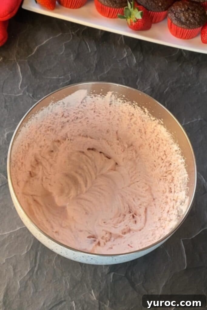 whipping cream and powdered sugar (in mixing bowl) being whipped with electric hand mixer