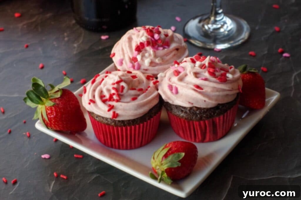 Effortless Elegance Red Wine Chocolate Cupcakes 2 Three elegantly frosted chocolate red wine cupcakes on a white plate, ready to be enjoyed.