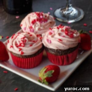 Effortless Elegance Red Wine Chocolate Cupcakes 9 Three chocolate red wine cupcakes on a white plate, elegantly frosted and garnished.