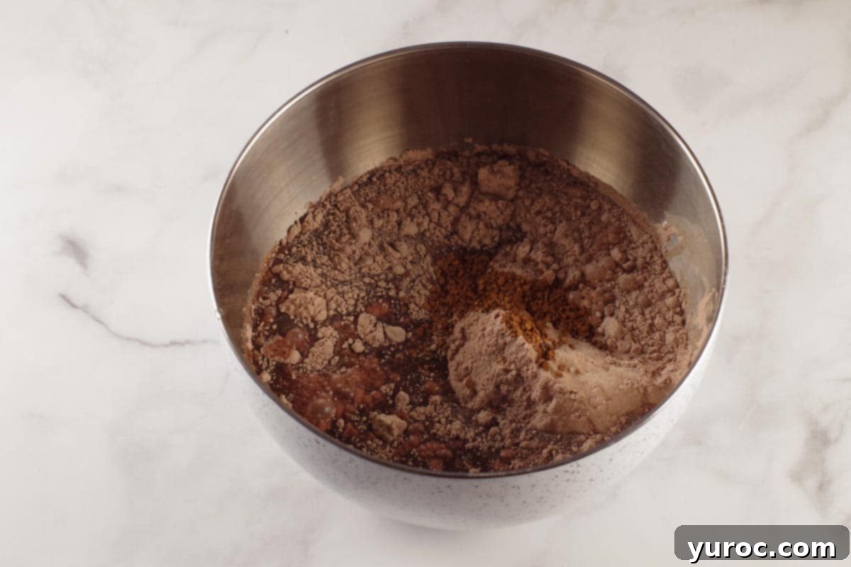 Effortless Elegance Red Wine Chocolate Cupcakes 4 Red wine chocolate cupcake ingredients in a large mixing bowl, ready to be blended.