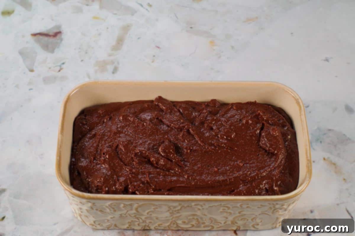 Blender Bliss Chocolate Zucchini Bread 11 Smooth chocolate blender zucchini bread batter poured into a greased loaf pan, ready for baking.