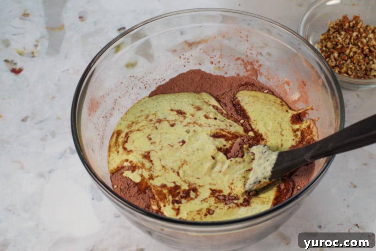 Blender Bliss Chocolate Zucchini Bread 8 The blended wet ingredients being poured into the bowl of dry ingredients, ready to be combined for the chocolate zucchini bread batter.