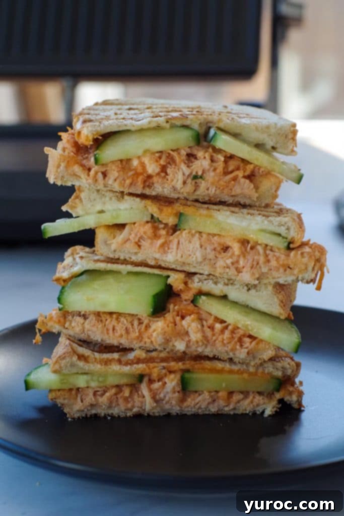 45 Effortless Tips for Boosting Your Produce Intake 9 buffalo chicken panini on a black plate with panini press in background