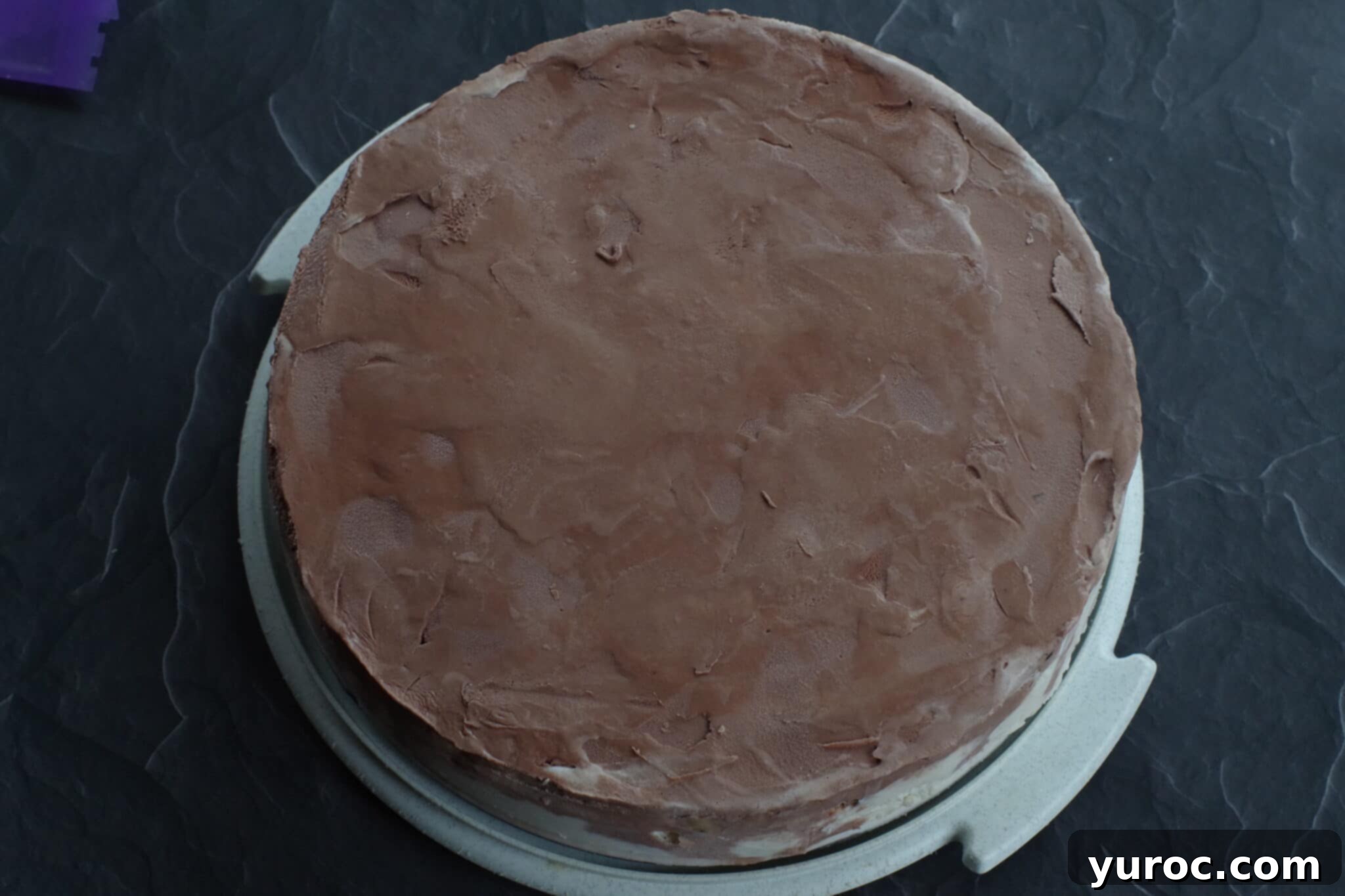 sides removed from cake and cake on a platter
