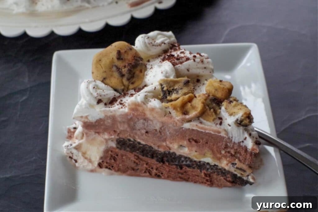 piece of cookie dough ice cream cake on a white plate with a fork